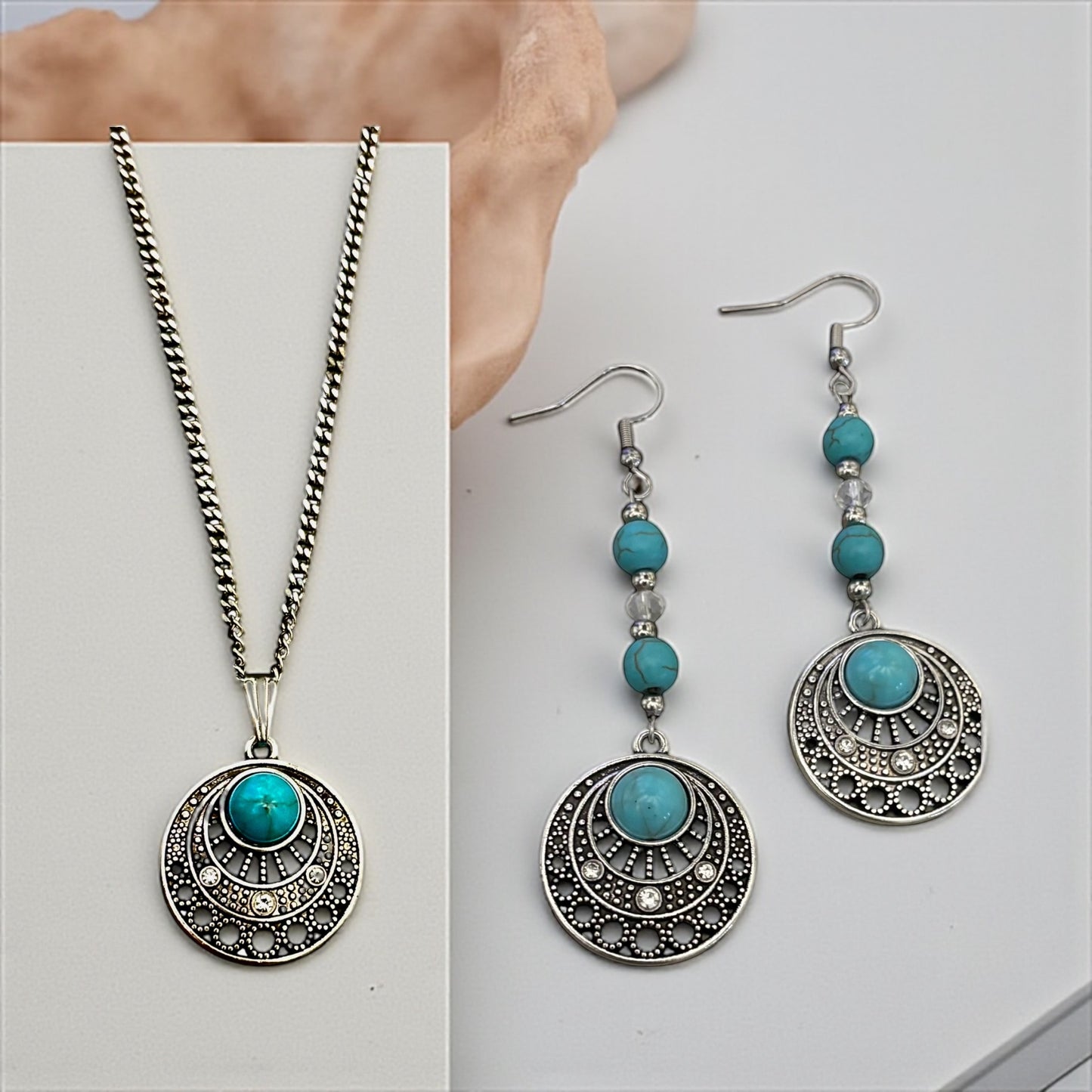Jewelry set with necklace and earrings featuring turquoise stones on a white background